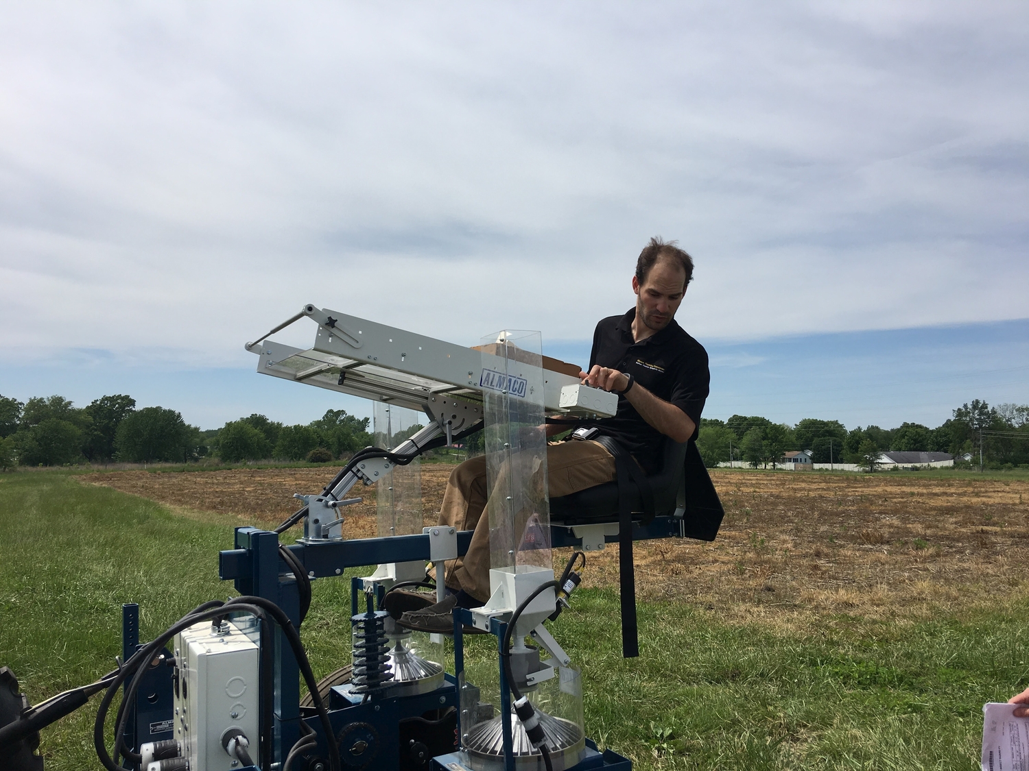 Professor Tim Beissinger on a tractor during the planting phase of the experiment
